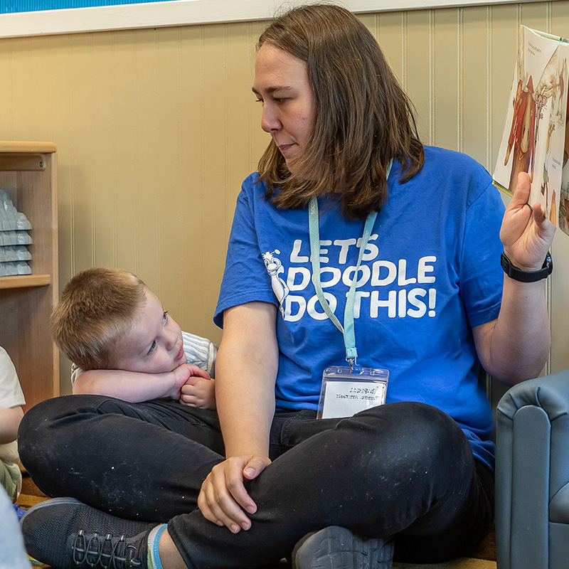 Toddler teacher reading to the class